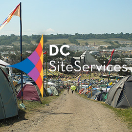 DC Site Services logo over Glastonbury Festival view from the farm