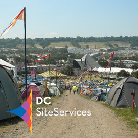 DC Site Services logo over Glastonbury Festival view from the farm photo