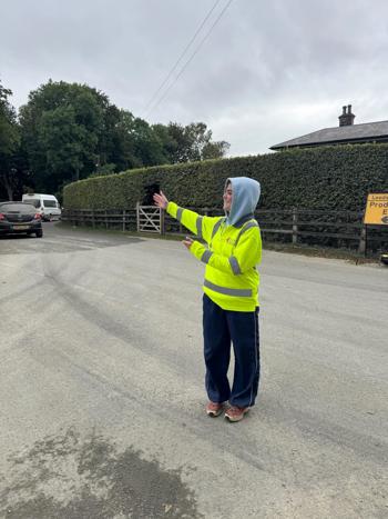 Crew Member Directing Traffic Hood Up