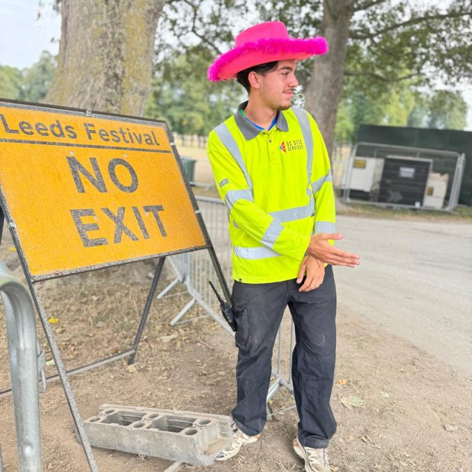Crew Member Directing Taffic By No Exit Sign