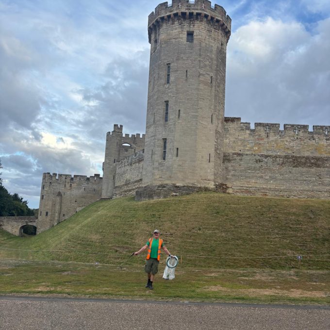 Crew Member Infront Of Castle