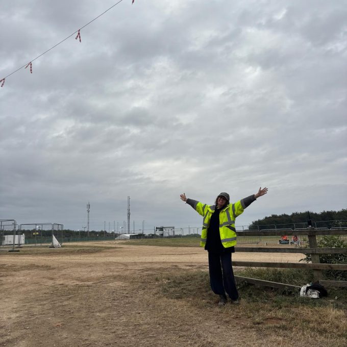 Crew Member Smiling With Arms In Air