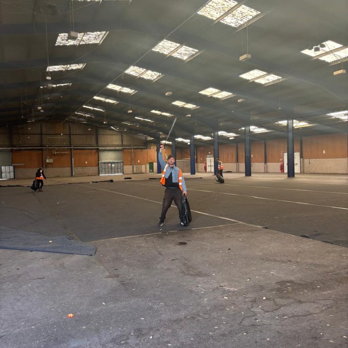 Ian Wearing Short Denim Jacket Holding Litter Pick & Bag