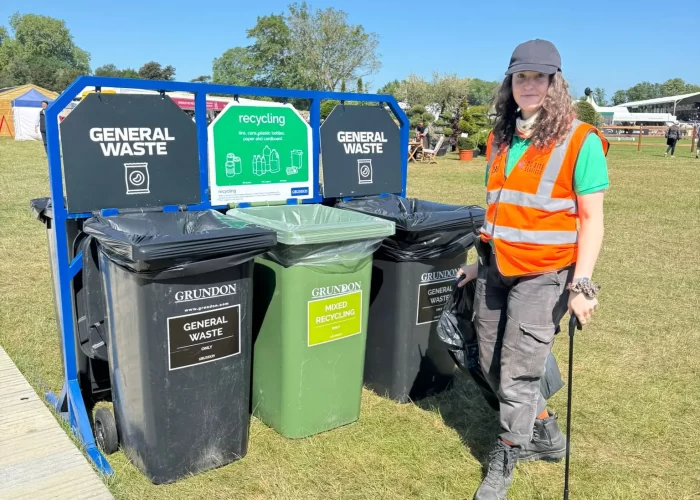 Crew member with litter pick by the bins