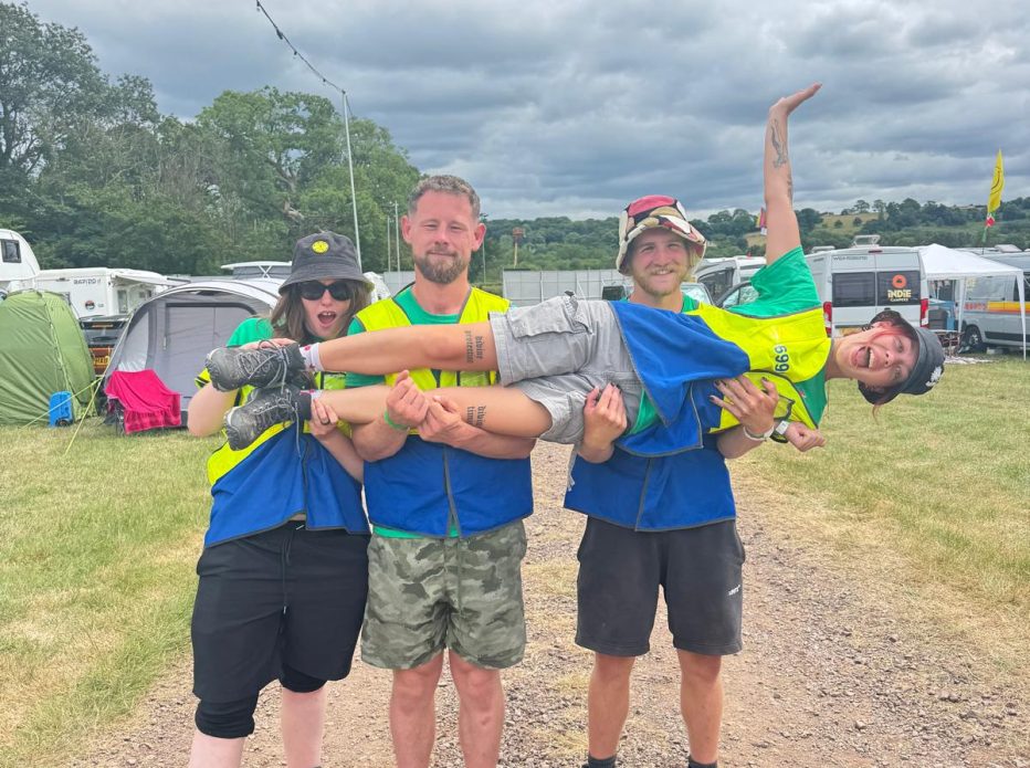 Crew posing for photo whilst holding another crew member
